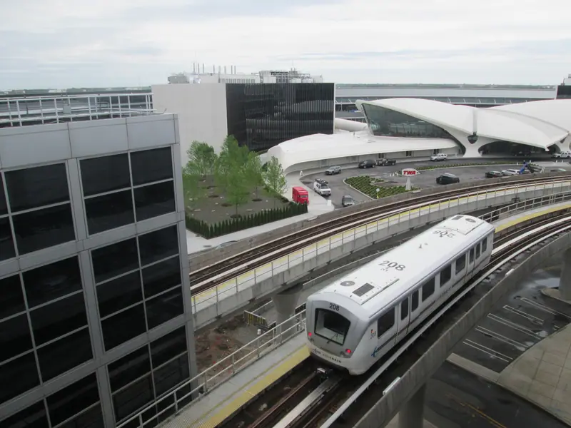 The AirTrain pulling into JFK Terminal 5, with the TWA Flight Center behind it