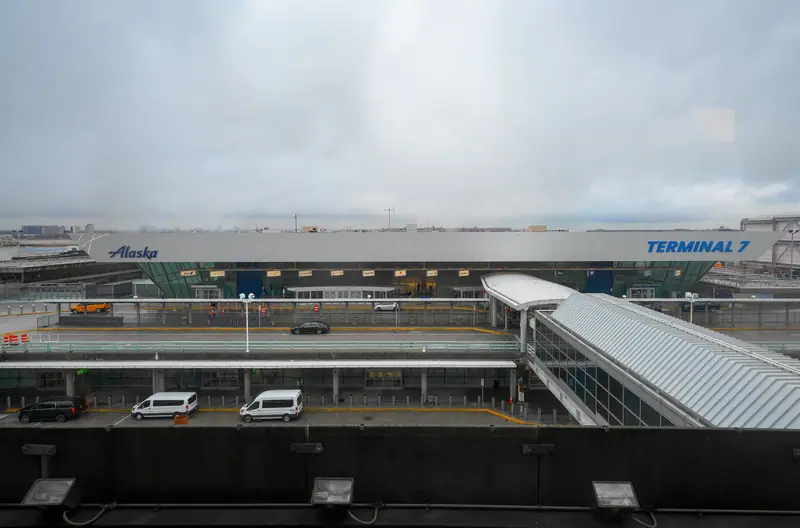 The front of JFK Terminal 7 with its sign and the AirTrain walkway