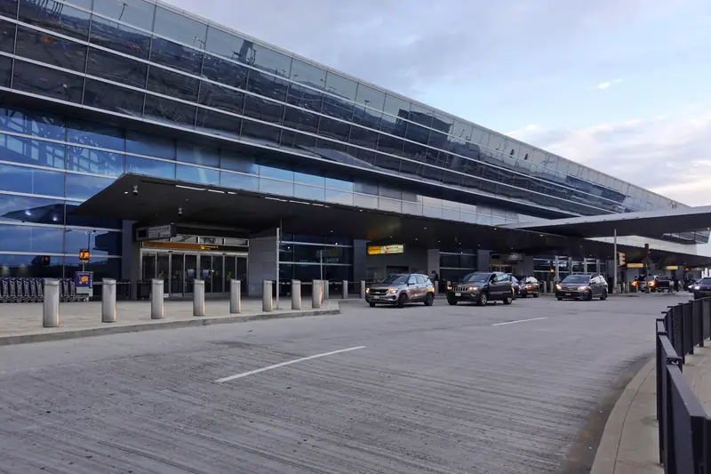 The front of JFK Terminal 8 and its arrivals road